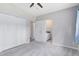 Spacious main bedroom with ceiling fan, gray carpet, double closet, and an attached bathroom at 3515 Leslie Dr, Orlando, FL 32806