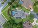 Aerial view of the home showcasing the screened pool, fire pit, manicured landscaping, and proximity to the road at 3619 King George Dr, Orlando, FL 32835