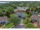 Aerial view showcasing the property lines, nearby lake, professional landscaping, screened pool, and manicured lawn at 3619 King George Dr, Orlando, FL 32835
