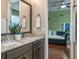 Elegant bathroom with double vanity sinks and stylish decor, opens to a bedroom with a comfortable daybed at 3619 King George Dr, Orlando, FL 32835