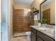 Stylishly designed bathroom with walk-in shower, granite vanity and modern fixtures offers a spa-like experience at 3619 King George Dr, Orlando, FL 32835