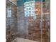 Modern bathroom shower boasts sleek tile work, glass enclosure, and elegant fixtures for a luxurious experience at 3619 King George Dr, Orlando, FL 32835