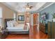 Another view of the main bedroom showing tray ceiling, access to the bathroom, and the hardwood flooring at 3619 King George Dr, Orlando, FL 32835