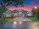 Stunning single-story home featuring a brick driveway and lush landscaping in a well-maintained community at 3619 King George Dr, Orlando, FL 32835