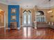 Bright foyer featuring hardwood floors, a decorative glass front door, and ample natural light from large windows at 3619 King George Dr, Orlando, FL 32835