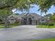 Beautiful single-story home with manicured landscaping and a circular paver driveway at 3619 King George Dr, Orlando, FL 32835