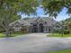 Beautiful single-story home with manicured landscaping and a circular paver driveway at 3619 King George Dr, Orlando, FL 32835