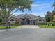 Beautiful single-story home with manicured landscaping and a circular paver driveway at 3619 King George Dr, Orlando, FL 32835