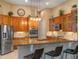 Well-appointed kitchen featuring stainless steel appliances, granite countertops, and modern lighting fixtures at 3619 King George Dr, Orlando, FL 32835