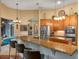 Bright, eat-in kitchen with stainless steel appliances, granite countertops, and a breakfast nook with a window seat at 3619 King George Dr, Orlando, FL 32835