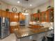 Modern kitchen featuring stainless steel appliances, granite countertops, and ample cabinet space with glass fronts at 3619 King George Dr, Orlando, FL 32835