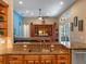 Open kitchen and living room featuring granite countertops, wood cabinets, and stainless steel appliances at 3619 King George Dr, Orlando, FL 32835