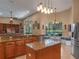 Spacious open kitchen with granite counters, a center island, and a breakfast nook overlooking the backyard pool at 3619 King George Dr, Orlando, FL 32835