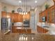 Modern kitchen with stainless steel appliances, granite countertops, and custom cabinetry offering ample storage space at 3619 King George Dr, Orlando, FL 32835