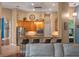 Bright kitchen featuring stainless steel appliances, a bar counter, and wooden cabinets with modern lighting at 3619 King George Dr, Orlando, FL 32835