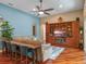 Stylish living room with hardwood floors, a built-in entertainment center, and a cozy seating area with modern decor at 3619 King George Dr, Orlando, FL 32835