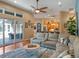 Cozy living room with a sectional sofa, large windows, and a view of the pool area with sliding glass doors at 3619 King George Dr, Orlando, FL 32835