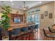 Open living space with a built-in entertainment center, sliding glass doors to the pool, and counter seating at 3619 King George Dr, Orlando, FL 32835