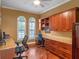 Inviting home office featuring custom wood cabinetry and granite countertops providing ample work and storage space at 3619 King George Dr, Orlando, FL 32835