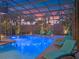 Inviting screened pool with attached spa, lounge seating and cool-blue Adirondack chairs at 3619 King George Dr, Orlando, FL 32835