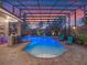 Inviting pool area with bar seating and lounge chairs under a screened enclosure for relaxation at 3619 King George Dr, Orlando, FL 32835