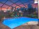 Relaxing pool area featuring comfortable lounge seating under a screened enclosure at 3619 King George Dr, Orlando, FL 32835