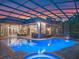An inviting screened pool with outdoor kitchen, bar area and lounge seating at 3619 King George Dr, Orlando, FL 32835