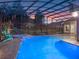 Inviting screened pool with attached spa, lounge seating and verdant landscaping at 3619 King George Dr, Orlando, FL 32835