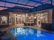Covered patio adjacent to the pool with lounge seating, bar, and kitchen access at 3619 King George Dr, Orlando, FL 32835