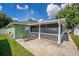 Backyard patio area with screen and lounge chair at 401 Gannet Ct, Kissimmee, FL 34759