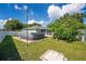 Backyard features a pool and green lawn, offering a great space for relaxation and recreation at 401 Gannet Ct, Kissimmee, FL 34759