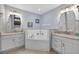 Bright bathroom showcasing double sink vanity and a large garden tub with tile surround at 401 Gannet Ct, Kissimmee, FL 34759