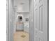 Bright bathroom featuring double doors, white walls, tile flooring, and vanity area with separate tub at 401 Gannet Ct, Kissimmee, FL 34759
