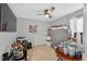 Cluttered room with gray walls, ceiling fan, and an abundance of furniture and personal belongings at 401 Gannet Ct, Kissimmee, FL 34759