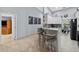 Kitchen featuring a breakfast bar with seating, white cabinets, granite countertops and stainless steel appliances at 401 Gannet Ct, Kissimmee, FL 34759
