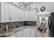 Kitchen with granite countertops, stainless appliances, white cabinets and a breakfast bar at 401 Gannet Ct, Kissimmee, FL 34759