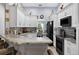 Kitchen with black appliances, granite countertops, tile backsplash, and a breakfast bar with seating at 401 Gannet Ct, Kissimmee, FL 34759