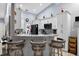 Kitchen with granite countertops, tile backsplash, white cabinets and a breakfast bar with seating at 401 Gannet Ct, Kissimmee, FL 34759