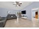 Comfortable living room featuring modern tile floors, high ceilings and a sliding glass door for natural light at 401 Gannet Ct, Kissimmee, FL 34759