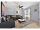 Comfortable living room features tile flooring, stylish decor, and a dark-gray sectional sofa at 401 Gannet Ct, Kissimmee, FL 34759