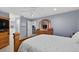 Spacious main bedroom features light blue walls, ceiling fan, and gorgeous wood furniture set with television at 401 Gannet Ct, Kissimmee, FL 34759