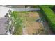 An aerial view shows a spacious backyard with a play set and secure fencing for privacy and safety at 413 Pursley Dr, Deland, FL 32724