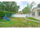 Expansive backyard with lush lawn, playset, and privacy fence at 413 Pursley Dr, Deland, FL 32724