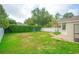 Spacious backyard with a playground, white fence, and lush landscaping perfect for outdoor activities and relaxation at 413 Pursley Dr, Deland, FL 32724