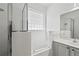 Bathroom featuring soaking tub, glass shower, and natural light at 413 Pursley Dr, Deland, FL 32724
