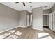 Neutral paint and light-colored wood floors give this bedroom a welcoming feel at 413 Pursley Dr, Deland, FL 32724
