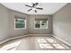 This bedroom is bright and features two windows, neutral walls, and wood floors at 413 Pursley Dr, Deland, FL 32724