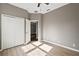 Bright bedroom with wood floors, ceiling fan, and closet at 413 Pursley Dr, Deland, FL 32724