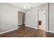 Open-concept dining room features hardwood floors and arched doorways leading to kitchen at 413 Pursley Dr, Deland, FL 32724
