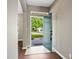 Inviting entryway boasts neutral walls, tile transition, wood floors, and a view of the front yard at 413 Pursley Dr, Deland, FL 32724